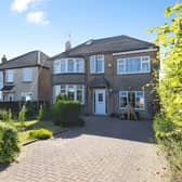 The impressive frontage reflects the generous scale of this substantial detached family home set on a private plot.