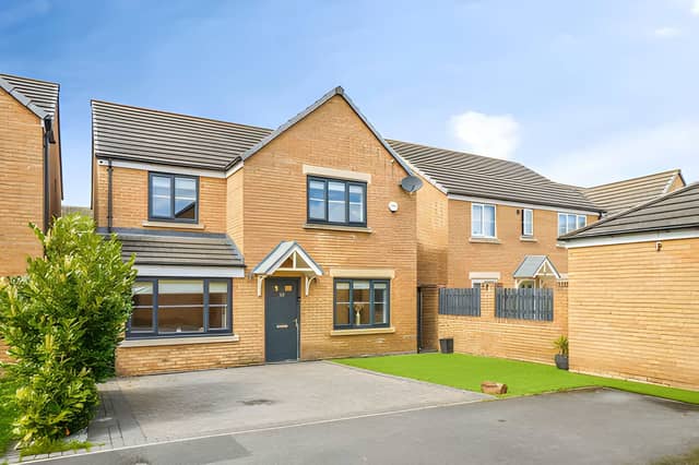 The attractive frontage and driveway offer a welcoming first impression of this spacious modern family home.