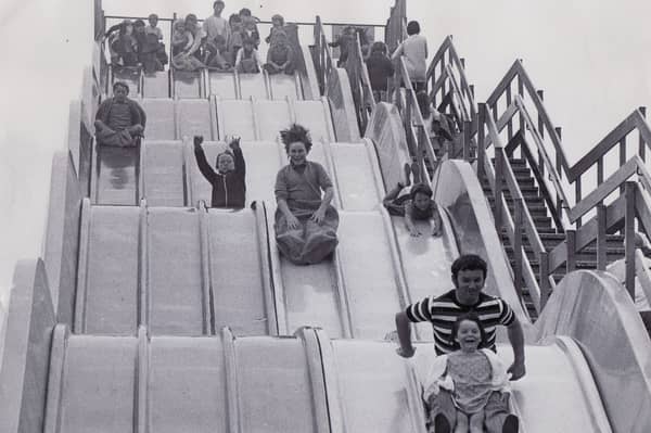 Youngsters hurtle down a huge slide on the promenade at Bridlington in July 1972