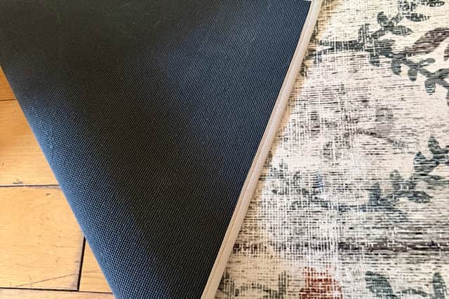 The solid rubber backing anchors the rug solidly to the floor