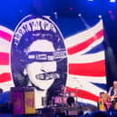Sex Pistols flying the flag for punk rebellion with their iconic God Save the Queen imagery towering over the stage at Scarborough Open Air Theatre.