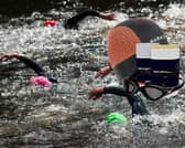 Open-water swimmers on course, pictured alongside key gear including the Speedo Biofuse 2.0 goggles, Nabaiji neoprene swim cap, and Zone3 anti-chafing balm.