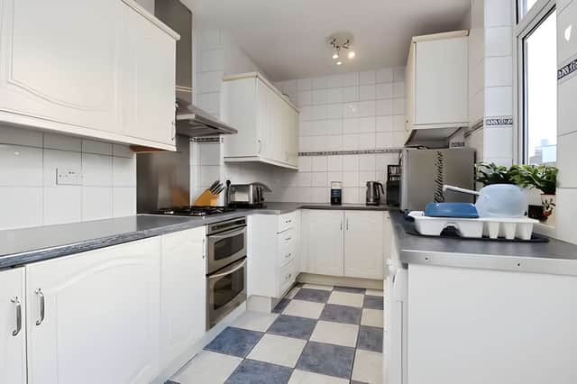 The contemporary kitchen connects effortlessly with the garden, making it an ideal hub for busy family life and relaxed entertaining
