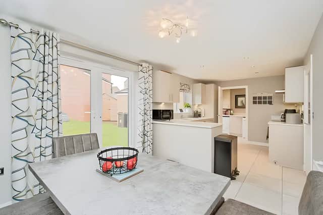The spacious open-plan kitchen diner has been designed as the social heart of the home, bringing everyone together for family meals and entertaining alike