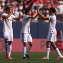 PUT IT THERE: Leeds United captain Ethan Ampadu, right, celebrates with goalscorer Brenden Aaronson and new signing Tarik Muharemovic.