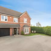 This impressive corner plot home offers a smart exterior and a glimpse of the spacious family living inside.
