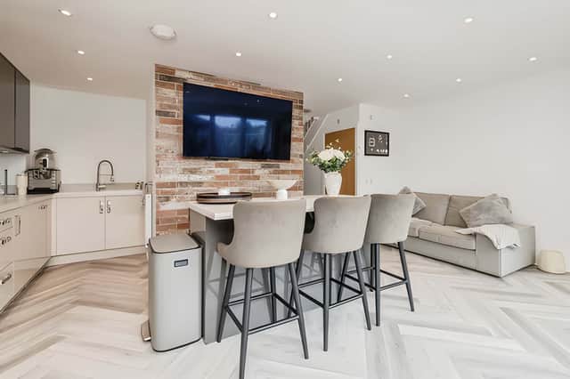 The open-plan kitchen and family area provides a stylish setting for cooking, dining and spending time together.