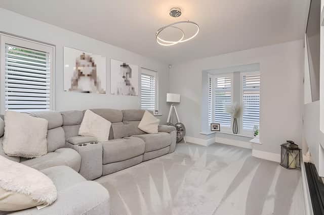 The bright lounge with media wall creates a welcoming space for relaxing and entertaining.