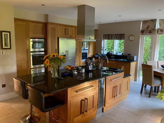 The contemporary open-plan kitchen forms the social heart of the home, blending cooking, dining and family living.