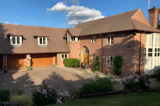 Behind private gates, this substantial village home makes a striking first impression in a secluded setting.