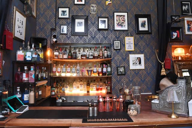After dark, sewing machines make way for a 1920s speakeasy.
