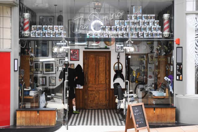 Lord’s Barbering. The wooden door leads down to the Domino Club.