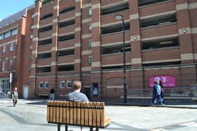 The bench facing a carpark outside The Brewery Tap near Leeds City Station, Leeds.