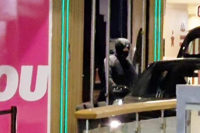 The ATM machine is seen to be visibly damaged, as men in balaclavas exited the car and opened the boot, before heading into the services' slot machine area.