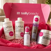 A selection of salon-quality haircare products from Sally Beauty, including Olaplex, Color Wow, Wella and Wunderbar, styled as part of an at-home haircare routine.