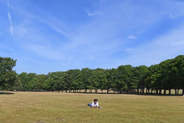 A sunbather on the parched grass in Hyde Park, Leeds.