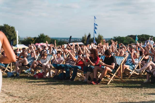 Festivalgoers enjoying live stage entertainment in the deckchairs at Temple Newsam Food Festival