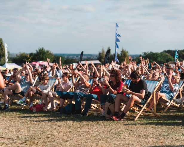 Festivalgoers enjoying live stage entertainment in the deckchairs at Temple Newsam Food Festival