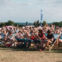 Festivalgoers enjoying live stage entertainment in the deckchairs at Temple Newsam Food Festival