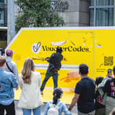 A member of the public takes a swing at the giant piñata during the interactive VoucherCodes.co.uk pop-up activation