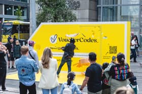 A member of the public takes a swing at the giant piñata during the interactive VoucherCodes.co.uk pop-up activation