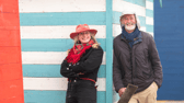 Lisa Lindqvist and Shane Green standing in front of a blue-striped beach hut