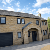 Set behind electric gates, the stone-built detached home makes a substantial first impression in one of New Farnley’s sought-after residential locations.
