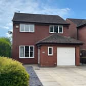 The detached Colton home combines a generous driveway, gated side access and an integrated garage, creating a practical approach to a property overlooking mature woodland.