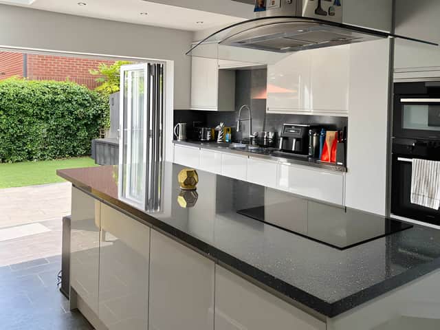 The expansive rear kitchen and dining space is designed around open-plan family living, with the woodland outlook adding to its setting.