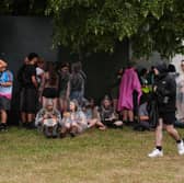 Festivalgoers shelter from the rain at Bramham Park on Saturday