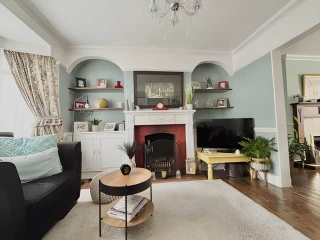 The bright through lounge combines generous natural light with an open fireplace and the home's distinctive character