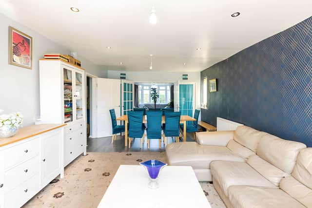 The formal living room offers a welcoming space to relax and entertain, with a distinctive bay window adding character