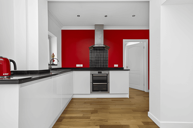 The well-appointed kitchen looks across the rear garden and sits alongside the home's dining and sun room spaces