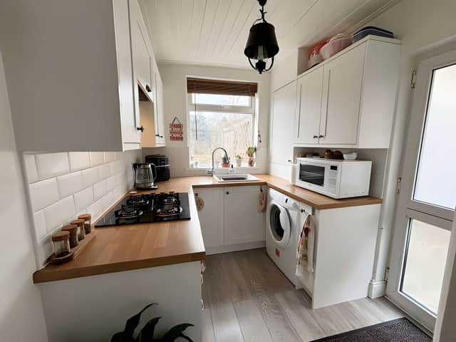 The bright, well-arranged kitchen has direct access to the rear garden, making the practical connection between indoors and outdoors especially useful