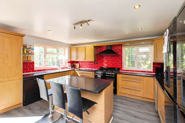 A contemporary fitted kitchen forms the heart of the home, with a central island, generous worktop space and room for informal dining
