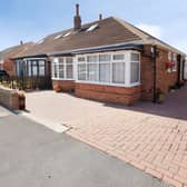 The bungalow is set back from High Moor Crescent behind a block-paved driveway and landscaped frontage