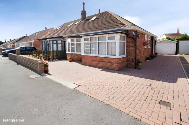 The bungalow is set back from High Moor Crescent behind a block-paved driveway and landscaped frontage