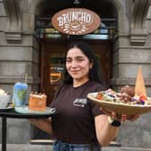 Elif Solovii, supervisor at Bruncho outside the café with trays of treats