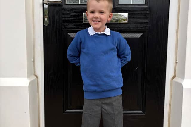Oliver outside his front door on his first day at primary school.