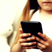 A first smartphone can give children greater independence – but parents should discuss online risks before handing one over.  
