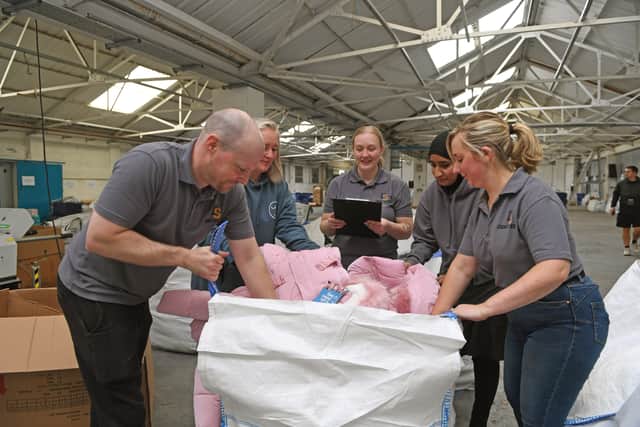 YCC staff and volunteers packing thousands of coats, shoes, pyjamas and bedding