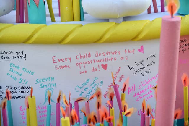 Members of the public were invited to add candles and messages of hope to the cake