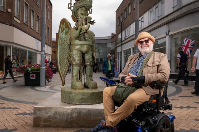 Artist Jason Wilsher-Mills pictured with his 'Amazon love God' statue
