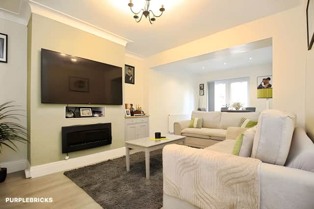 The spacious living room is joined by a second reception room