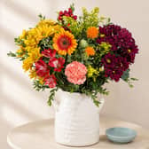 Bunches’ Autumn Sunrise bouquet combines warm yellow, orange, red and burgundy blooms for a colourful seasonal display.