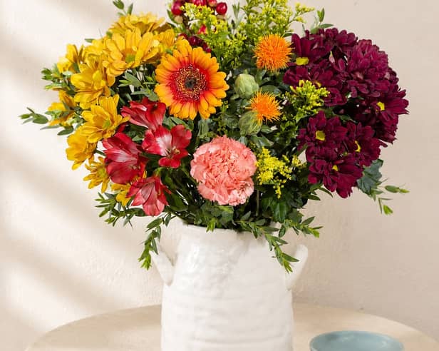 Bunches’ Autumn Sunrise bouquet combines warm yellow, orange, red and burgundy blooms for a colourful seasonal display.