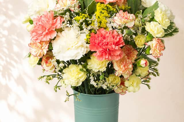 Bunches’ Autumn Brights bouquet mixes coral, cream and soft yellow flowers for a lighter take on seasonal autumn colour.