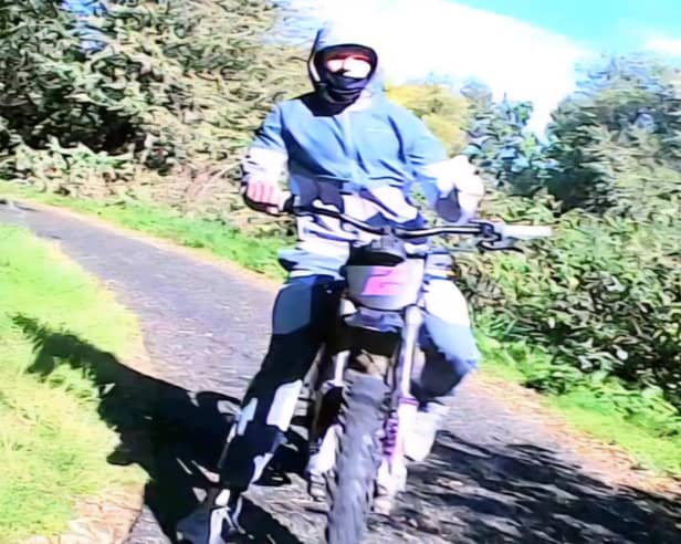 The e-bike rider is described as male, in his late teens to early 20s, wearing all grey clothing and a face covering.