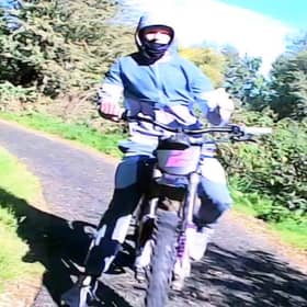The e-bike rider is described as male, in his late teens to early 20s, wearing all grey clothing and a face covering.