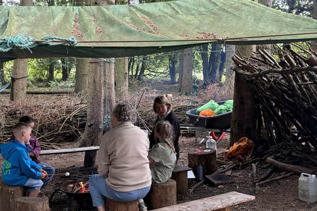 Family roasting marshmallows at woodland rave in Leeds